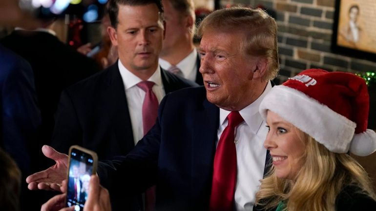 Former President Donald Trump greets supporters during a stop at...