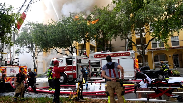 City of Miami Fire Rescue firefighters work at the scene...