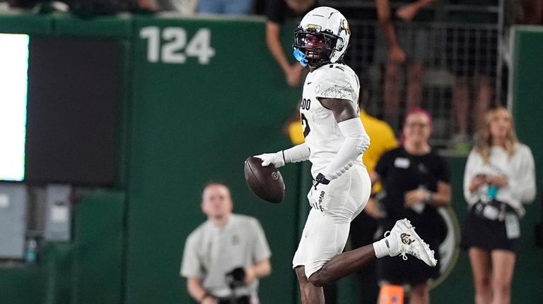 Colorado wide receiver Travis Hunter celebrates after intercepting a pass...