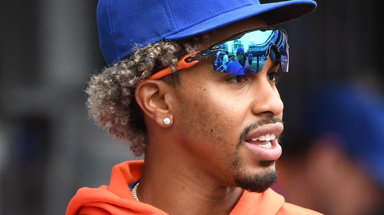 Mets shortstop Francisco Lindor looks on from the dugout during...