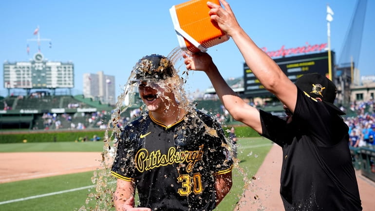 Pittsburgh Pirates starting pitcher Paul Skenes is doused by Martín...
