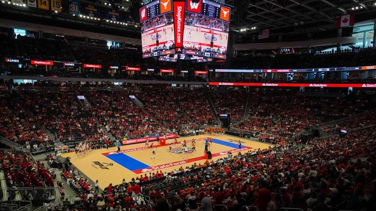 Fans in the Fiserv Forum watch during an NCAA Division...