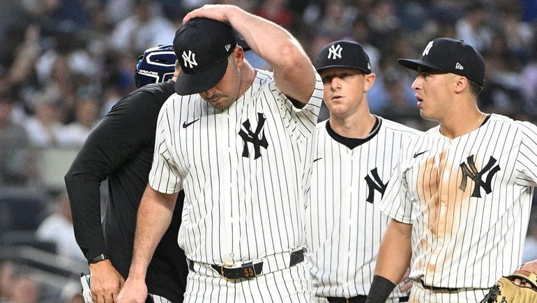 Yankees starting pitcher Carlos Rodón walks off the mound after...