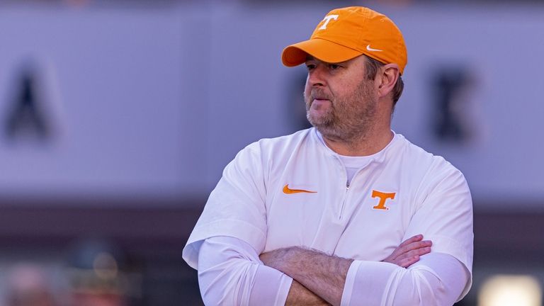 Tennessee head coach Josh Heupel watches his players warm up...