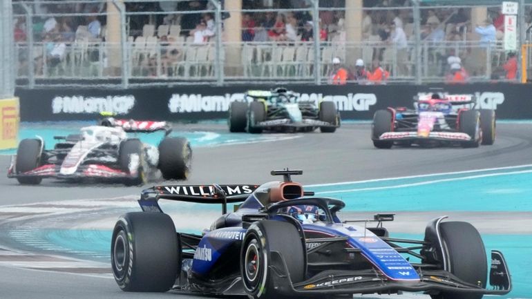 Williams driver Alexander Albon, foreground, of Thailand, steers into a...