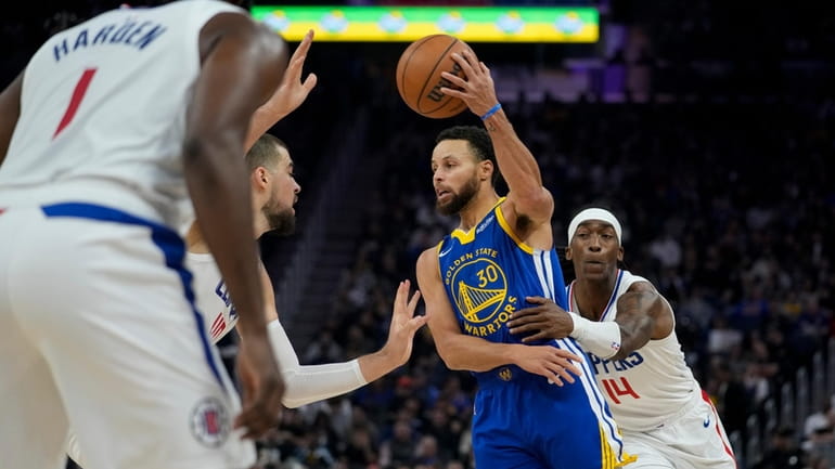 Golden State Warriors guard Stephen Curry (30) passes the ball...
