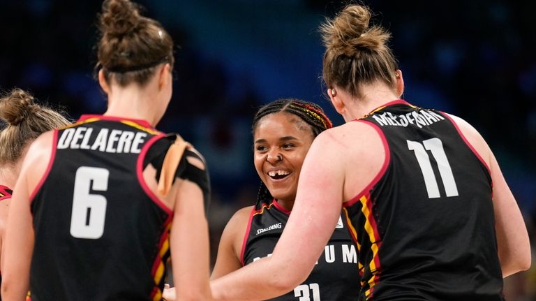 Maxuella Lisowa-Mbaka (31), of Belgium, celebrates with Antonia Delaere (6),...