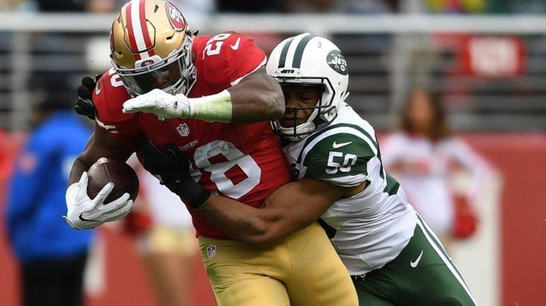 Carlos Hyde #28 of the San Francisco 49ers is tackled...
