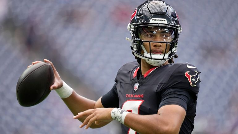 Houston Texans quarterback C.J. Stroud warms up before a preseason...