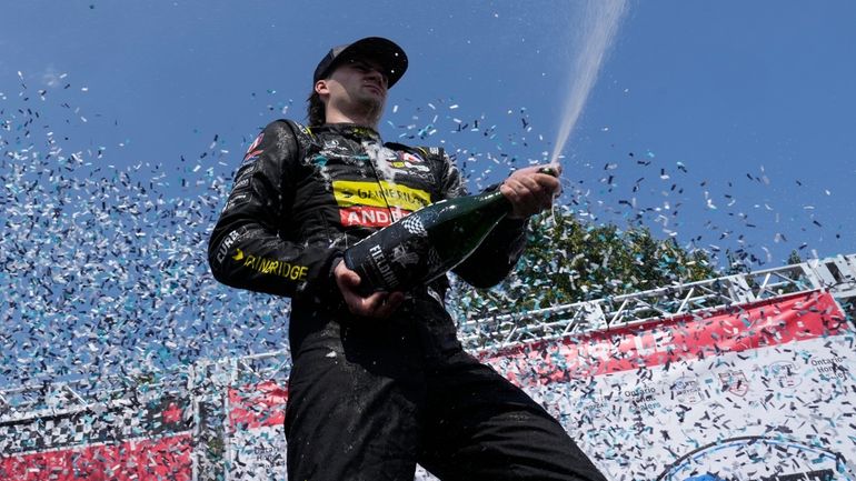 Colton Herta, of the United States, celebrates with his team...