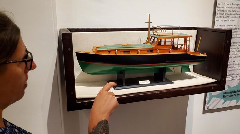 Curator Cori Convertito shows off a model of Ernest Hemingway's...