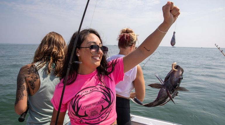 Arianna Castagna, of Port Jefferson, catches a black bass at...