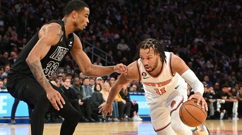 Knicks guard Jalen Brunson drives against Nets center Nic Claxton...