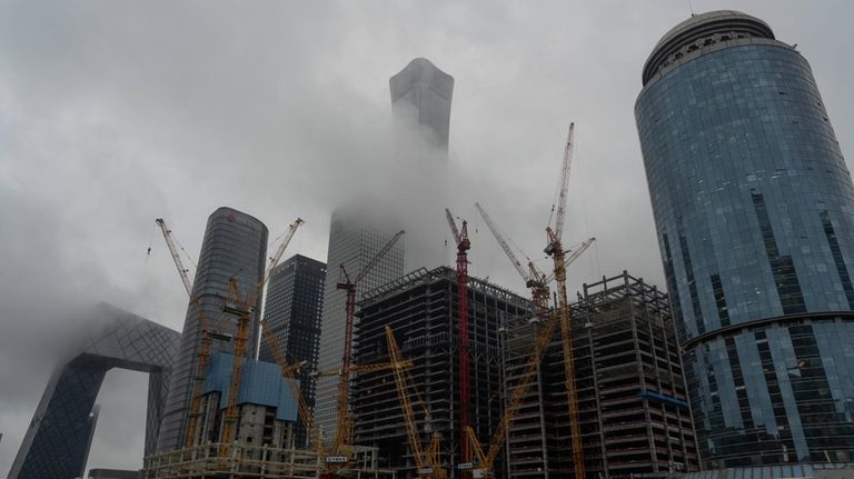 Construction cranes are seen near the China Zun, the tallest...