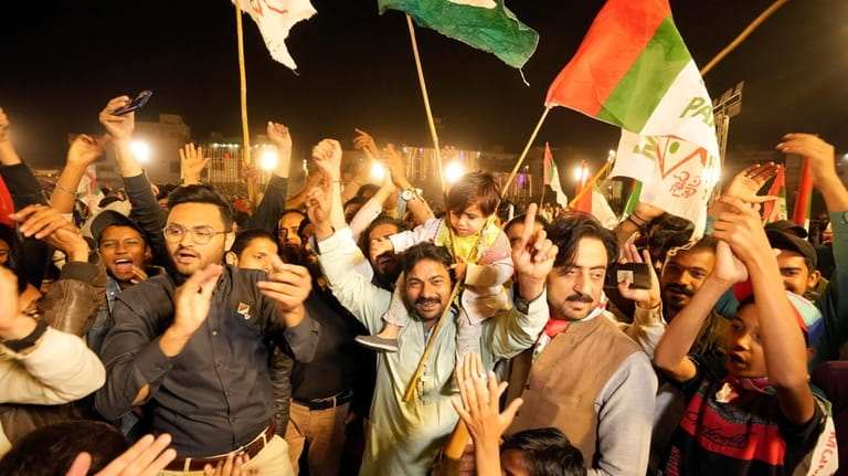 Supporters of Muttahida Qaumi Movement of Pakistan, celebrate victory of...
