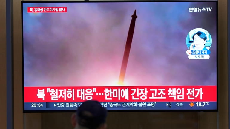 A TV screen shows a report of North Korea's missile...