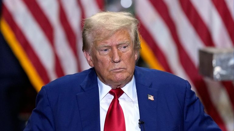 Republican presidential nominee former President Donald Trump listens at a...