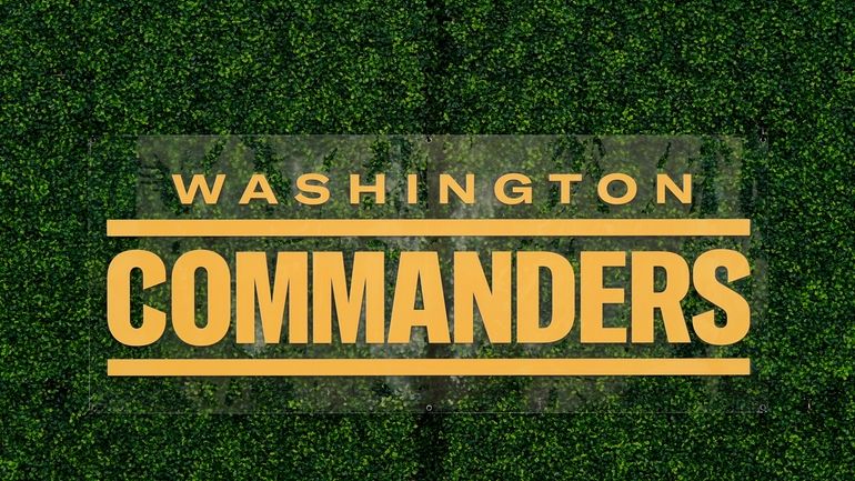 A Washington Commanders logo is displayed at an event, Feb....