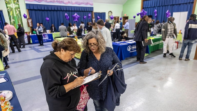 Jobseekers talk with potential employers during a job fair at...