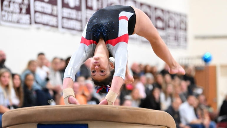 Hannah Hughes of Middle Country performs on the vault during the Suffolk gymnastic...