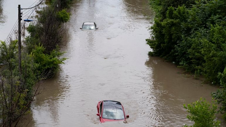 Cars are partially submerged in flood waters in the Don...