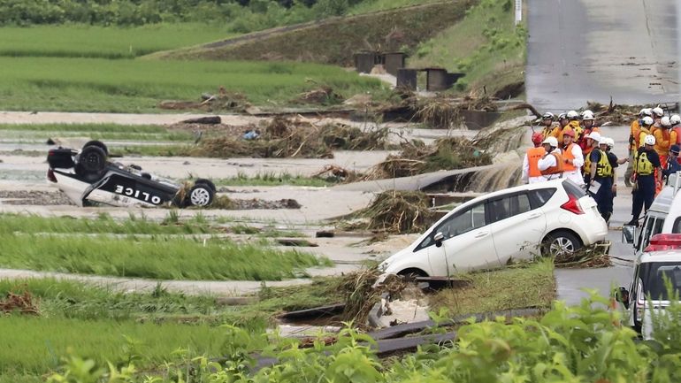 A police vehicle is seen overturned following a heavy rain...