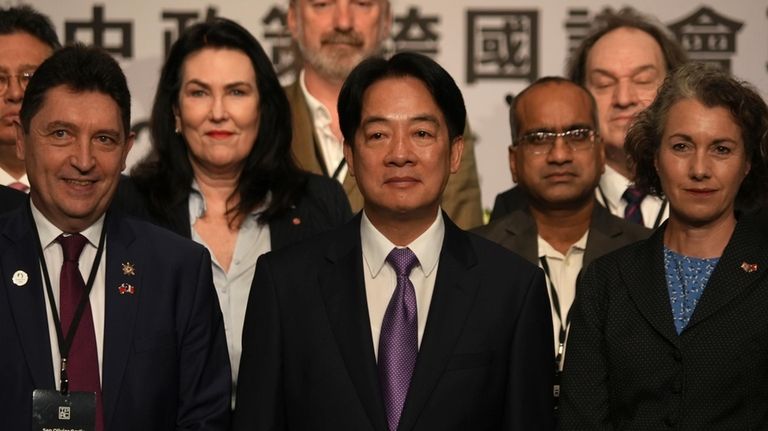 Taiwanese President Lai Ching-te, center, poses for photos at a...