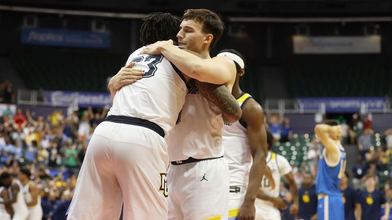 Marquette forward David Joplin (23) and guard Tyler Kolek (11)...