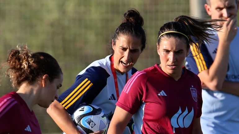 Spain's women's national team coach Montse Tome, centre, instructs players...