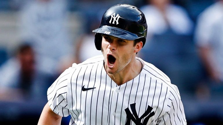 Yankees leftfielder Andrew Benintendi (18) rounds the bases after hitting...