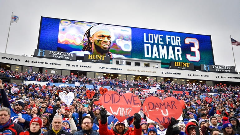 Fans stand in support for Buffalo Bills safety Damar Hamlin...