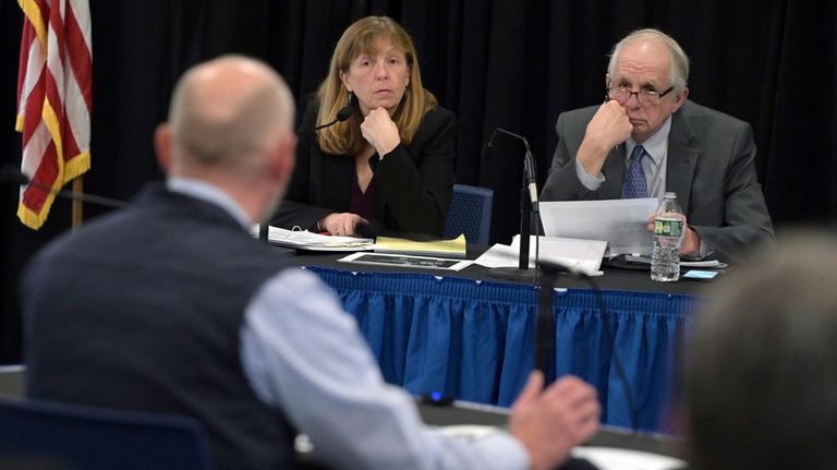 Independent Commission executive director Anne Jordan, rear left, and Independent...