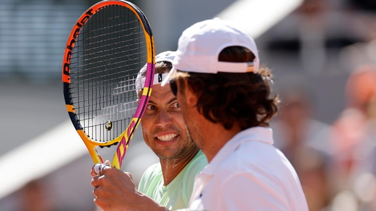 Spain's Rafael Nadal, left, talks with coach Carlos Moya during...