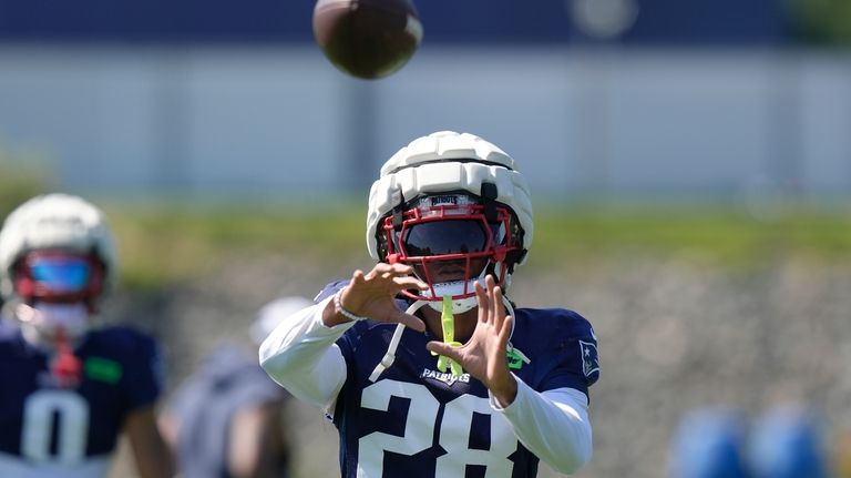 New England Patriots cornerback Alex Austin (28) catches the ball...