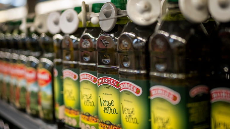 Bottles of virgin olive oil, sealed with an anti-theft system,...