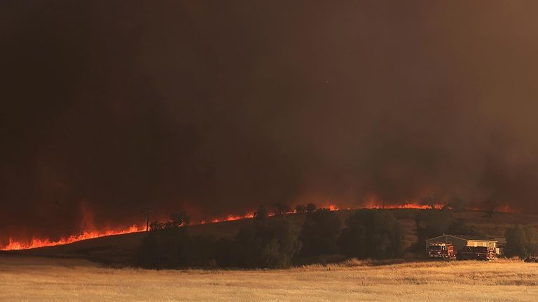 The Corral Fire bears down on a home west of...