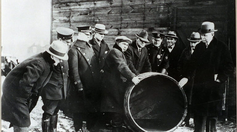Nassau County detectives and police officers with illegal whiskey confiscated...