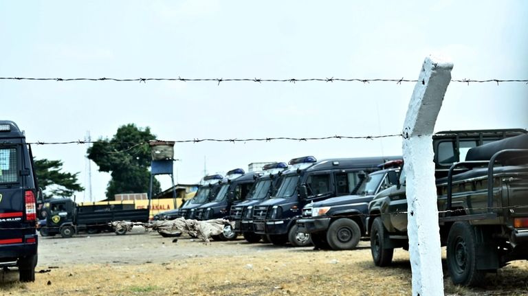 Police vehicles are seen outside the Makala Central prison in...