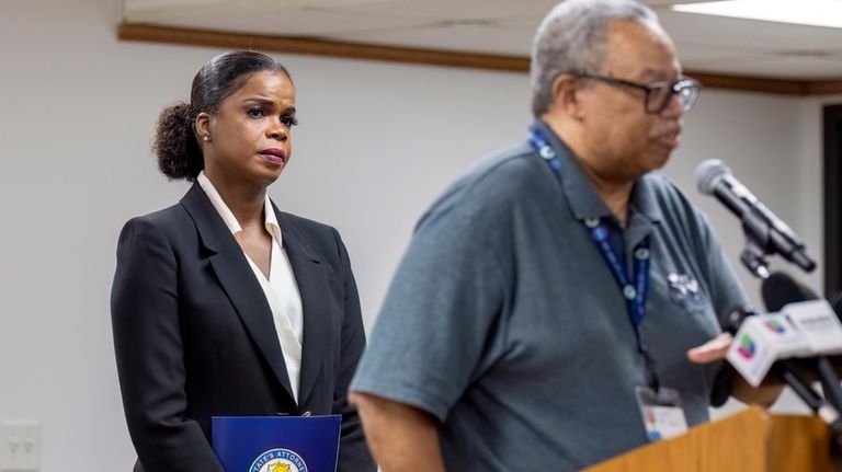 Cook County State's Attorney Kim Foxx, left, listens as Dorval...