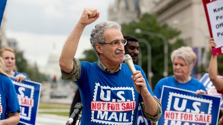 American Postal Workers Union president Mark Dimondstein speaks at an...