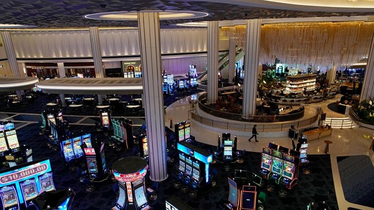 People walk through the casino area at the Fontainebleau Las...