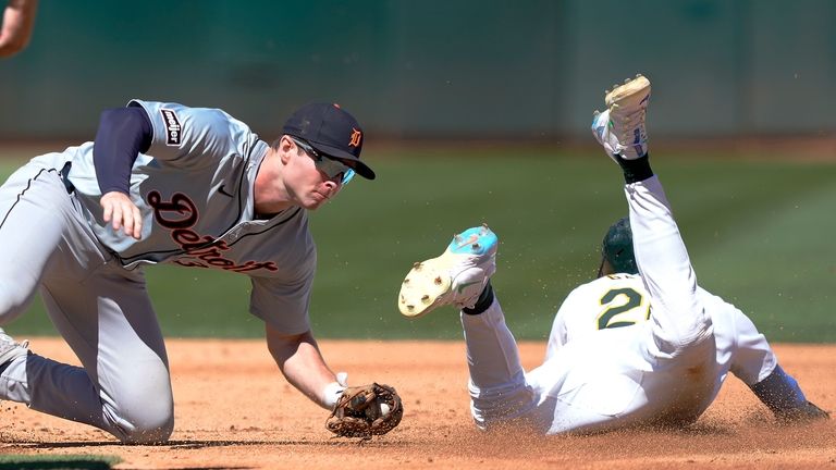 Oakland Athletics' Zack Gelof (20) steals second base past the...