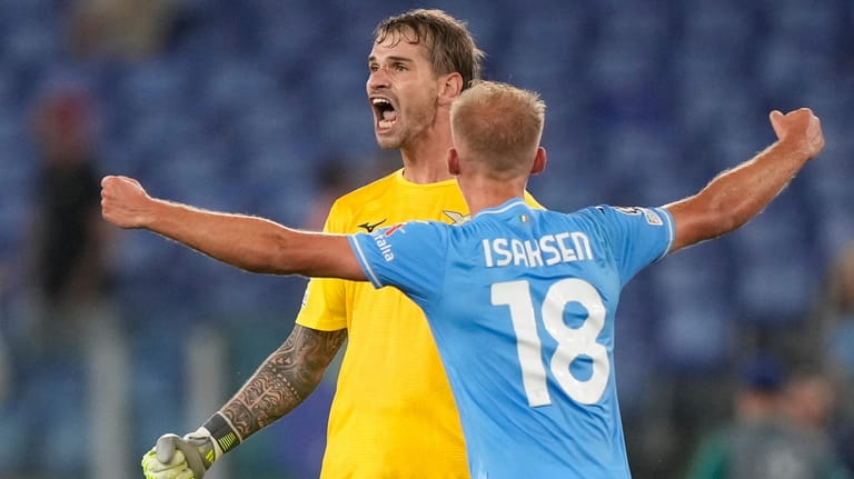 Lazio's goalkeeper Ivan Provedel, back, celebrates scoring his side's opening...