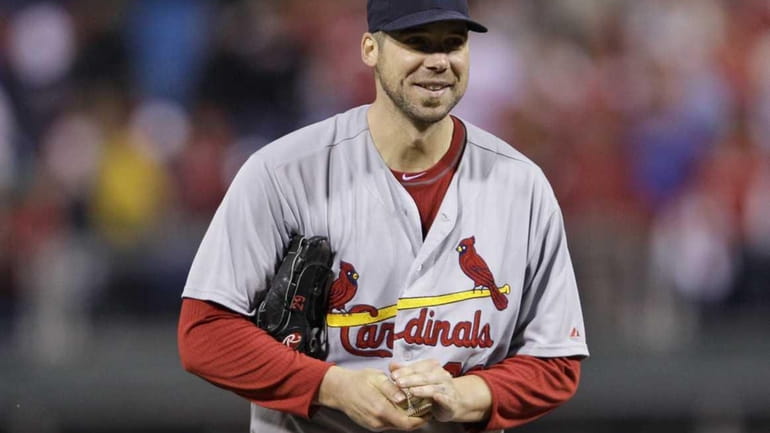St. Louis Cardinals starting pitcher Chris Carpenter smiles after getting...