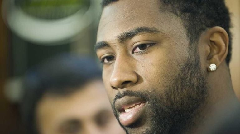 Jets cornerback Darrelle Revis talks to reporters in the locker...