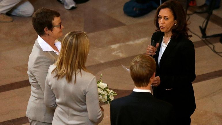 Attorney General Kamala Harris, right, officiates the wedding of Kris...