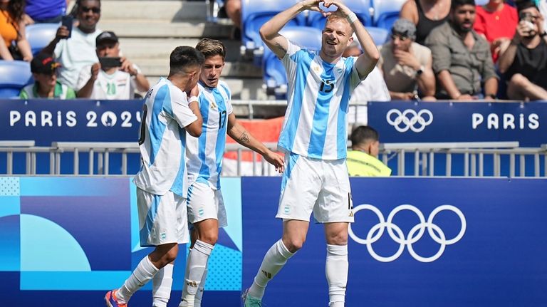 Argentina's Luciano Gondou, right, celebrates after scoring during the men's...