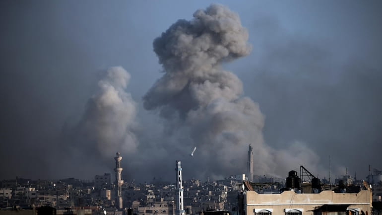 Smoke rises following Israeli bombardments in Khan Younis, southern Gaza...