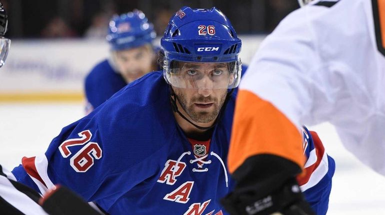 New York Rangers center Jarret Stoll faces off against Philadelphia...