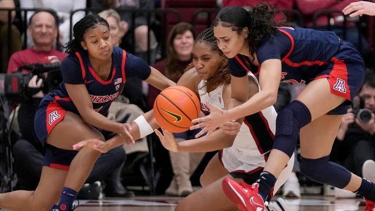 Arizona forward Esmery Martinez, right, grabs the ball in front...